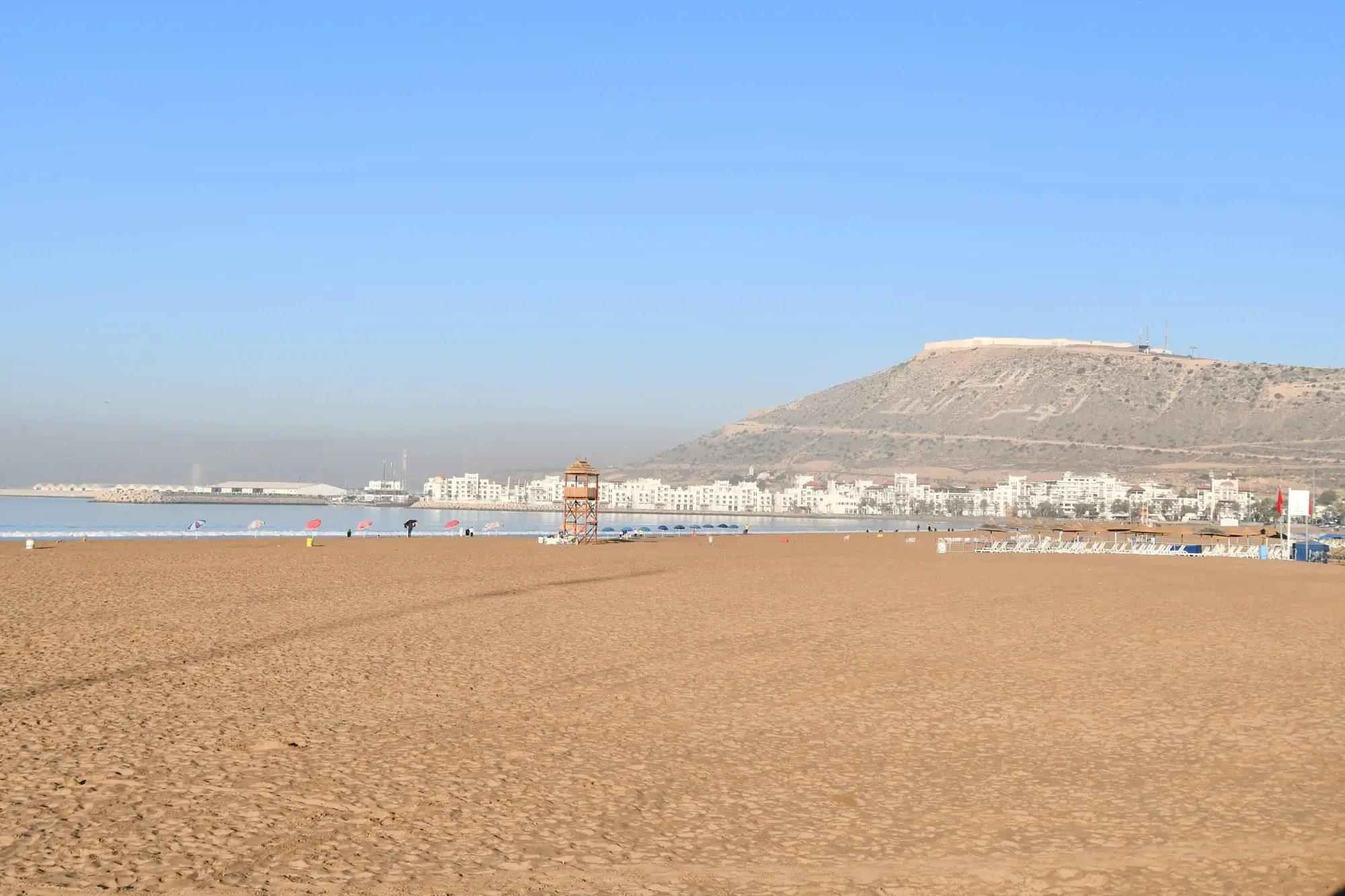 Agadir's wide sandy beach, with the seafront and the Kasbah hill beyond