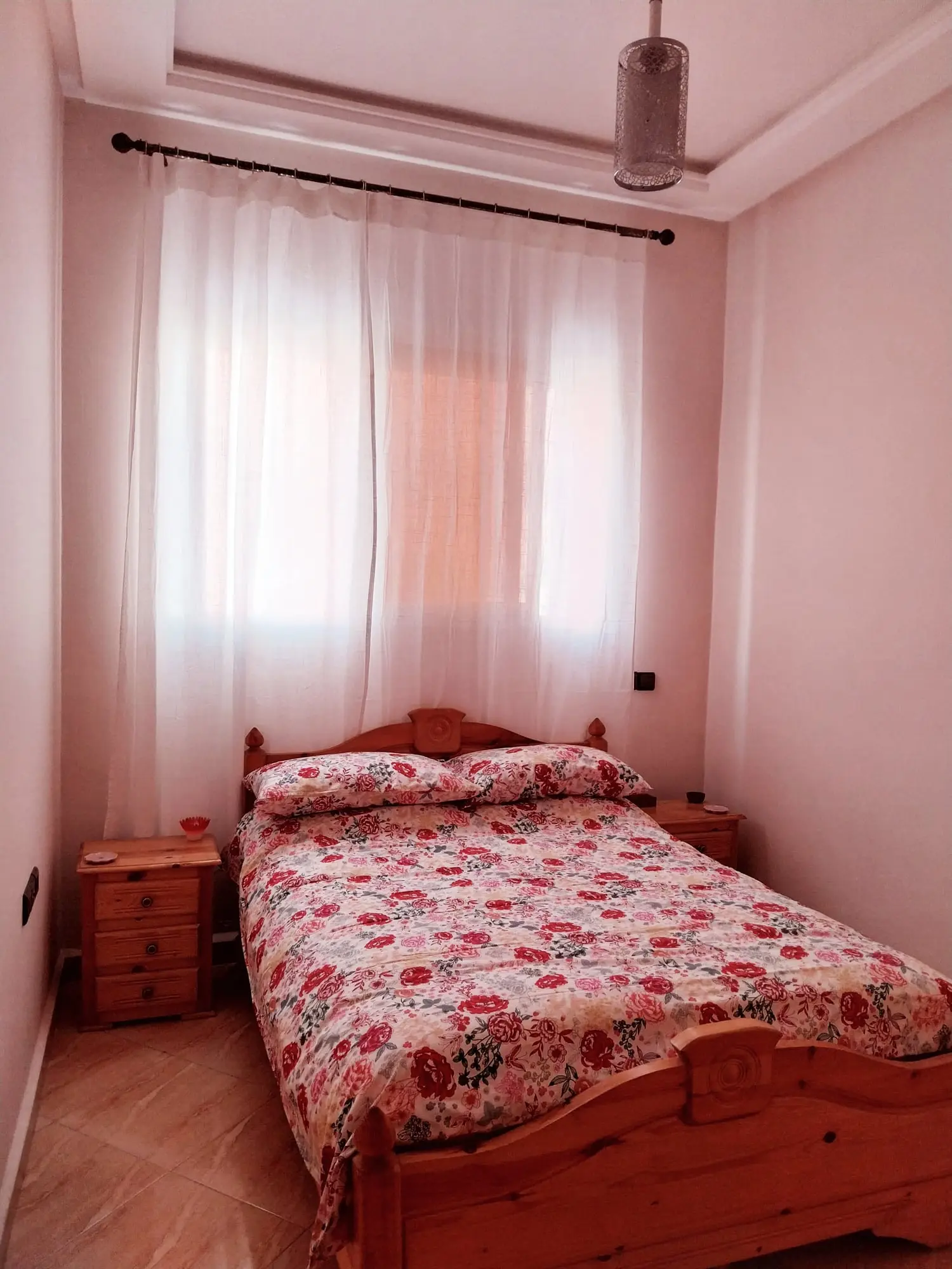 Double bedroom with a pine bed and a floral bedspread