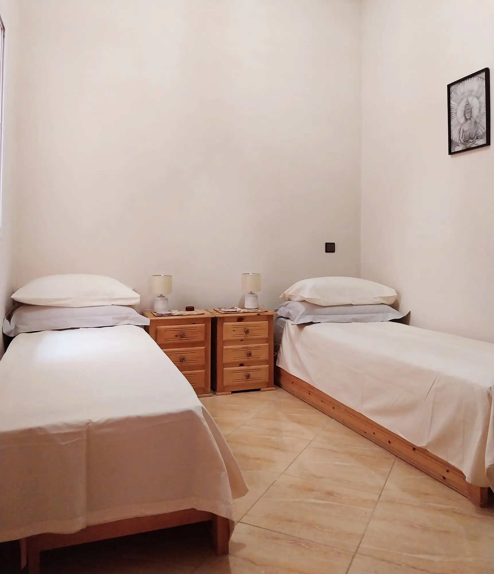 Twin bedroom with two single beds and pine bedside tables