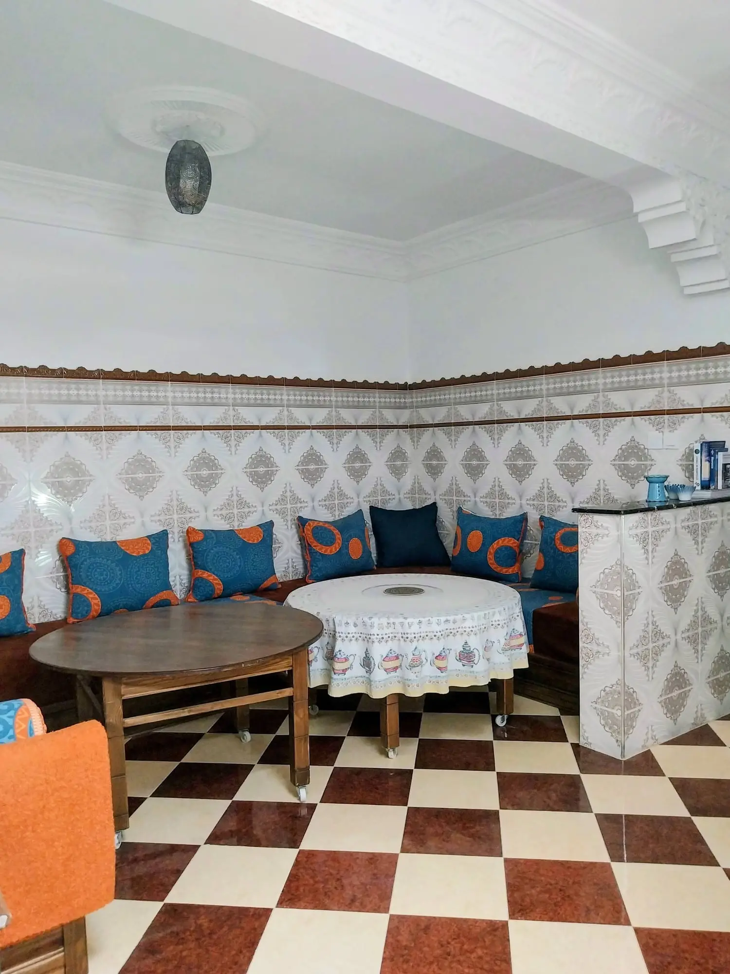 Salon seating around a round table on the checkerboard floor