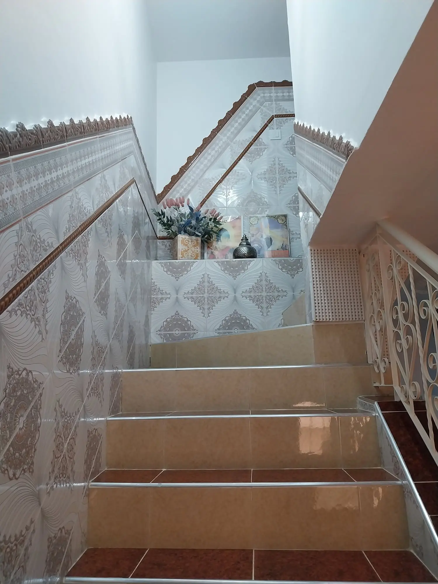 Tiled staircase with a wrought-iron balustrade